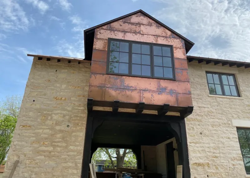 Copper metal panel facade on a stone building for Metal Roof Coating in Ferguson